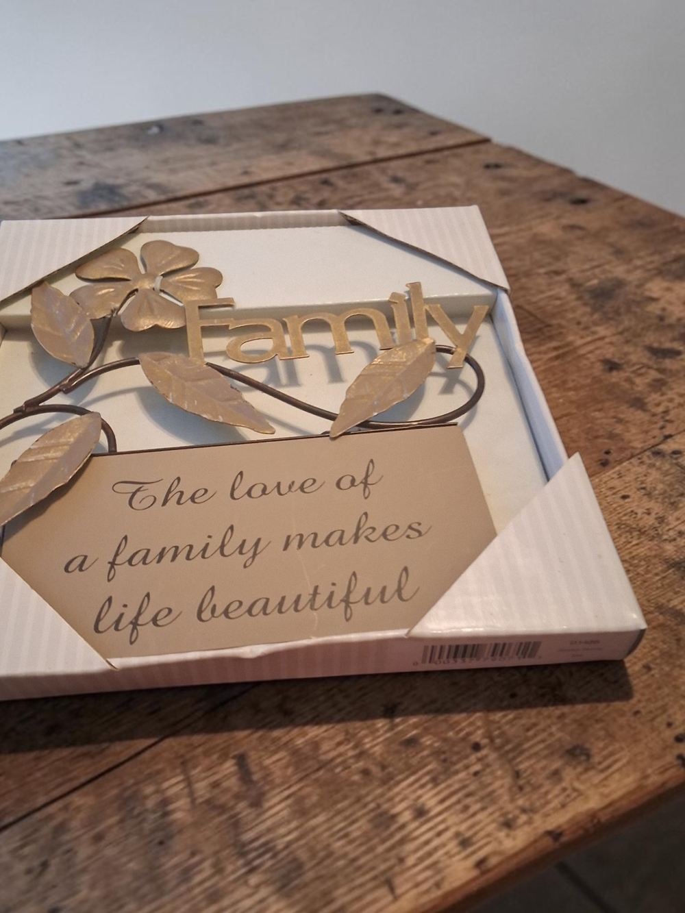 Love Of A Family wall art features gold-toned metal Flower And leaf accents